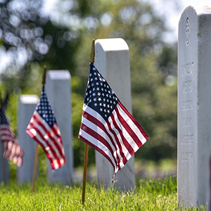 Flags in front of a veteran's grave